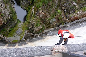 A person abseiling the Gordon Dam