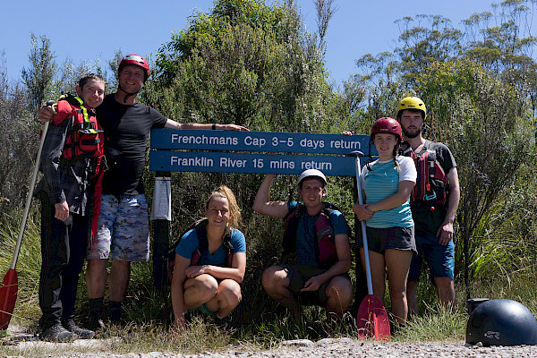 The group at the end of the trip, posing near the Frenchmans Cap, Franklin River sign.