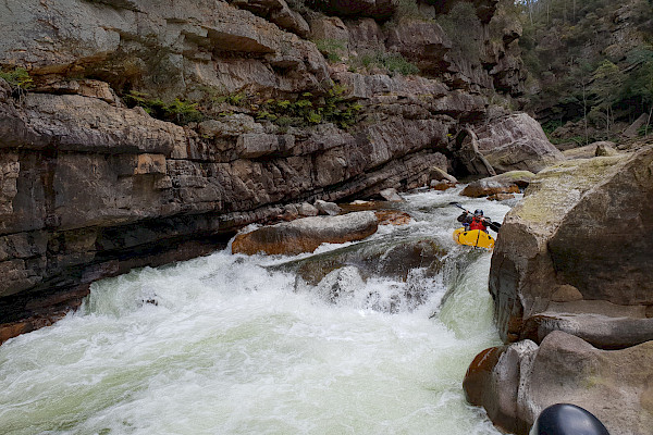 Pack raft approaching more difficult rapids