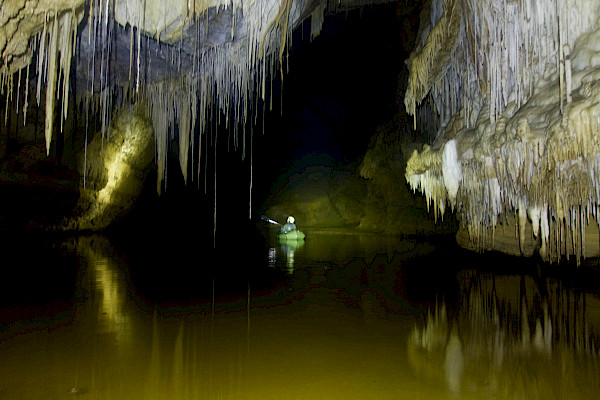 Person paddling on an underground lake