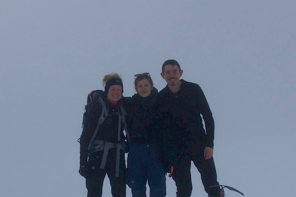 Walkers at top of mountain in poor visibility