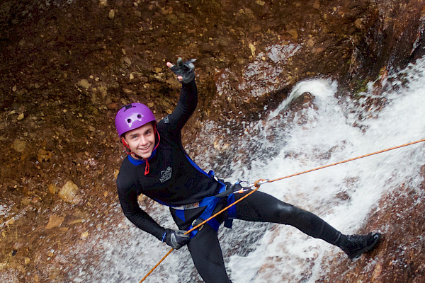 Person abseiling in a waterfall