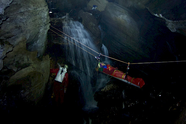 Stretcher suspended by ropes in the cave