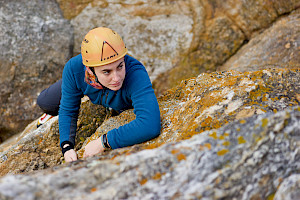 A female climbing a cliff