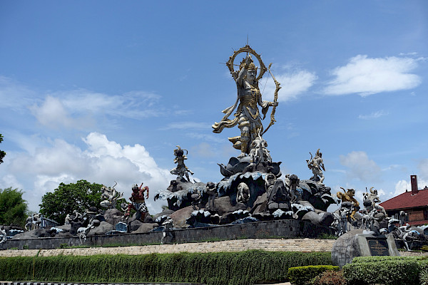 Statue with a group of smaller figures around a larger central one